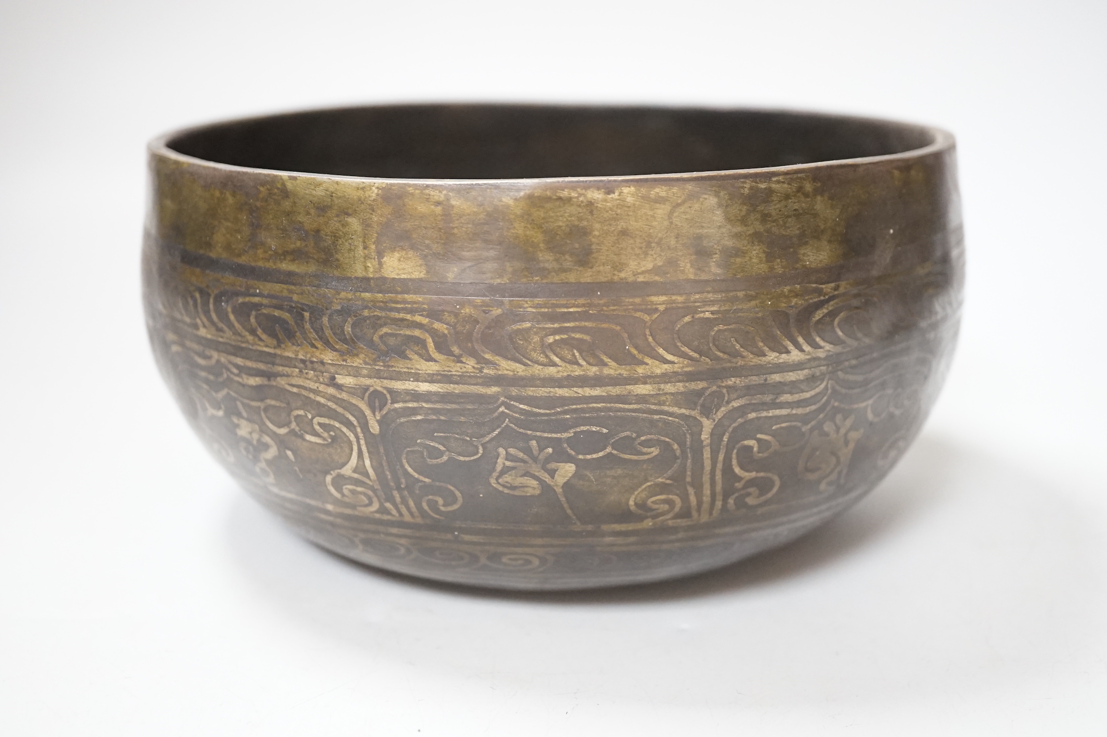 A Tibetan singing bowl with Sanskrit inscription, 19cm diameter